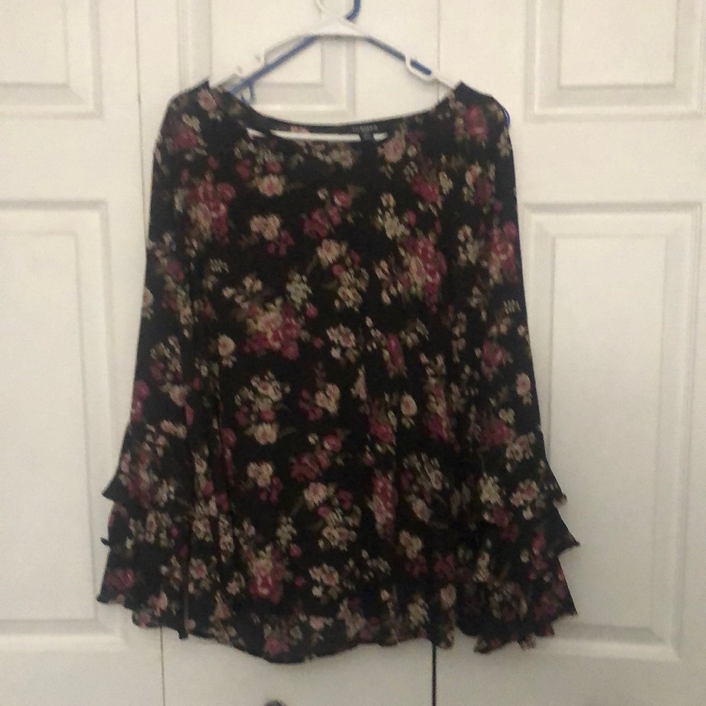 Beautiful top with flowing sleeves and a cross stitch neck.  Machine Wash.